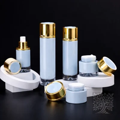 Glacier white skincare bottles and cosmetic jars with gold caps, arranged on white stands with one open jar in front.