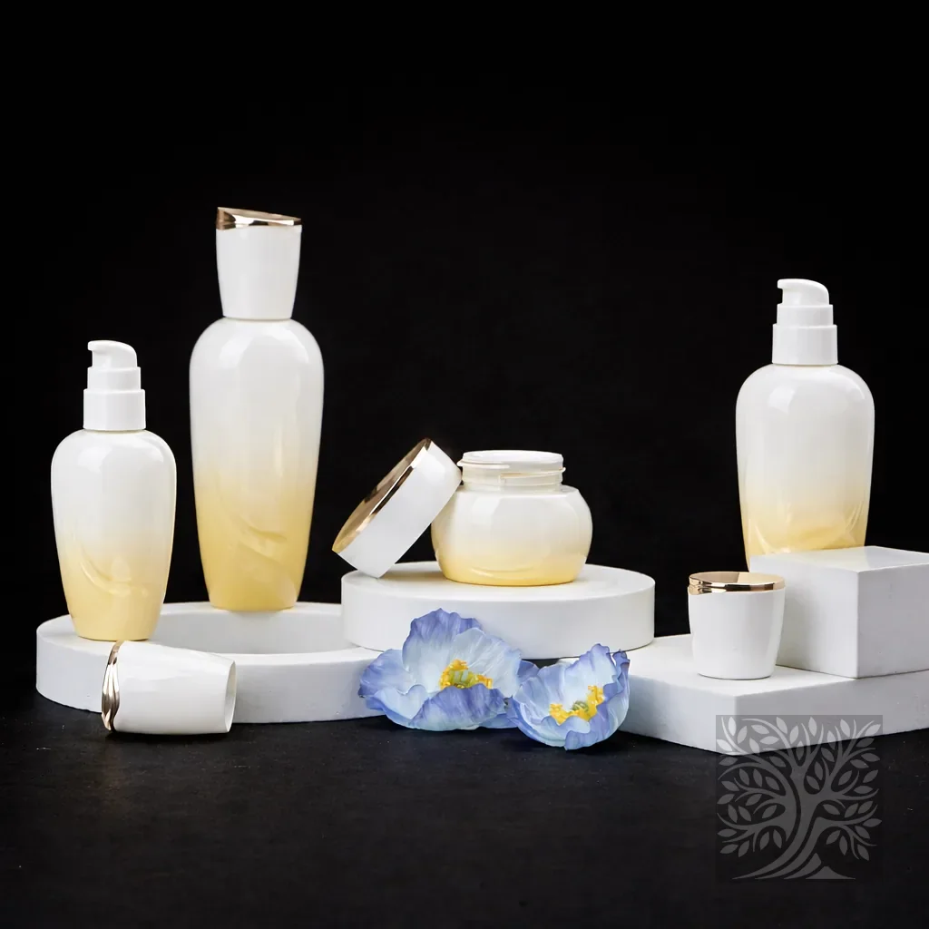 White to soft amber gradient glass skincare bottles and cosmetic jars with gold caps, styled with flowers on white platforms.