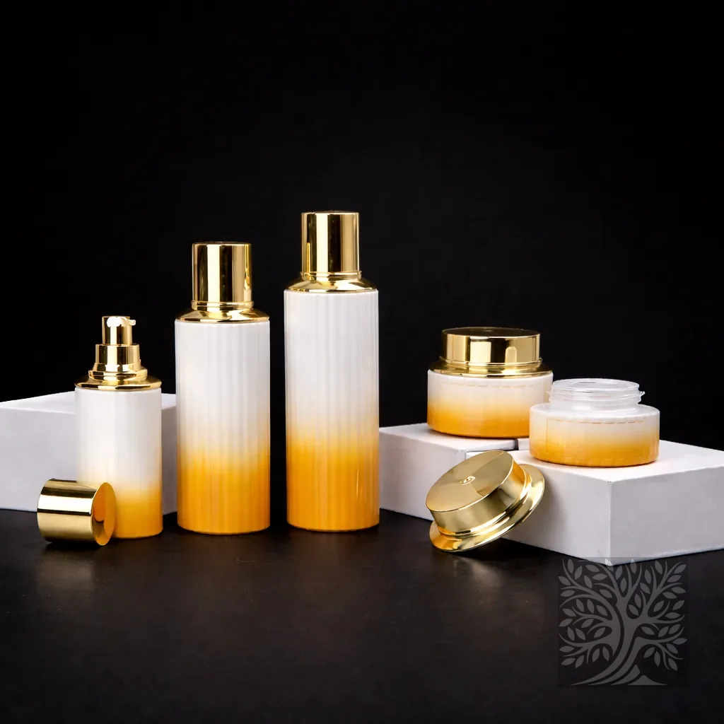 White to amber gradient glass skincare bottles and cosmetic jars with gold caps, arranged on white blocks in a warm display.