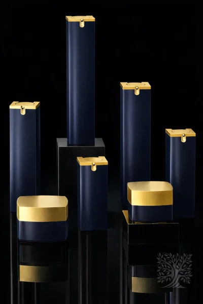Navy blue Skyscraper skincare bottles and cosmetic jars with gold caps, arranged in a clean geometric layout.
